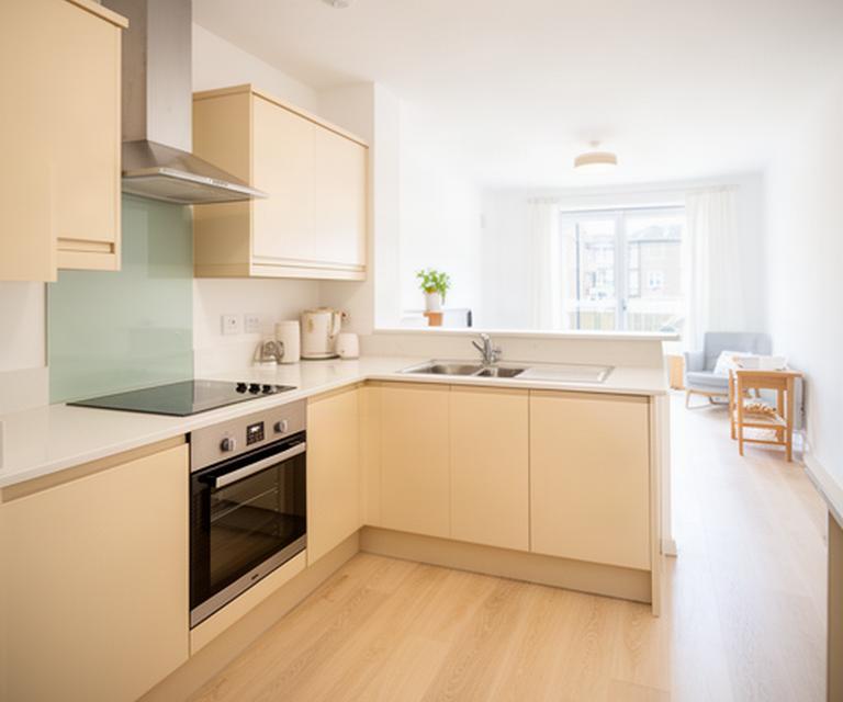 Bright rental apartment kitchen in Letterkenny prepared for a tenant handover, with clean worktops, cupboards and flooring